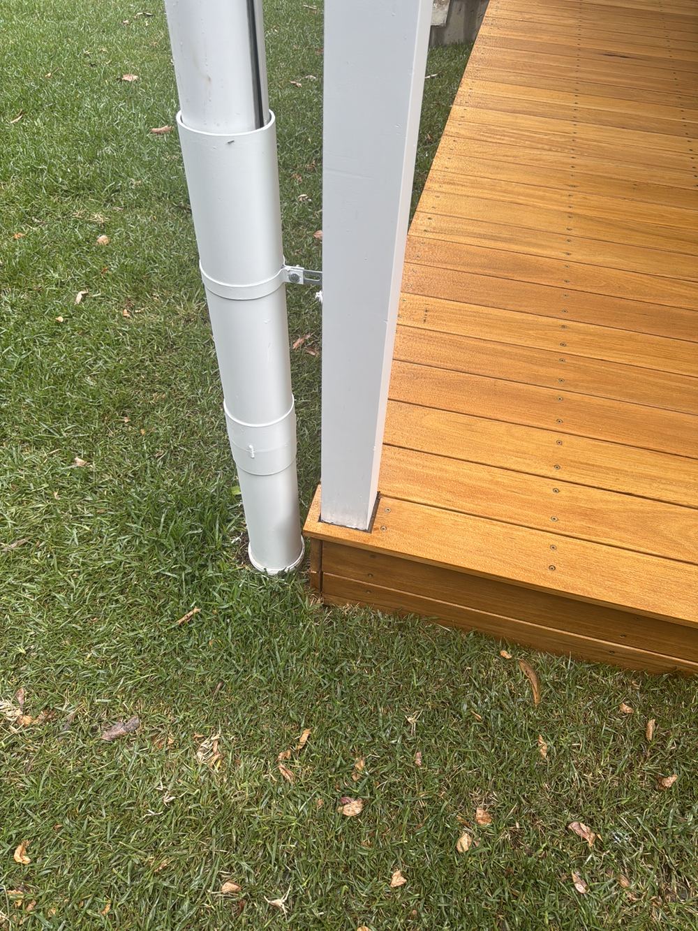 Support post buried in the ground, inviting rot and termites, found during a handover inspection in Castle Hill