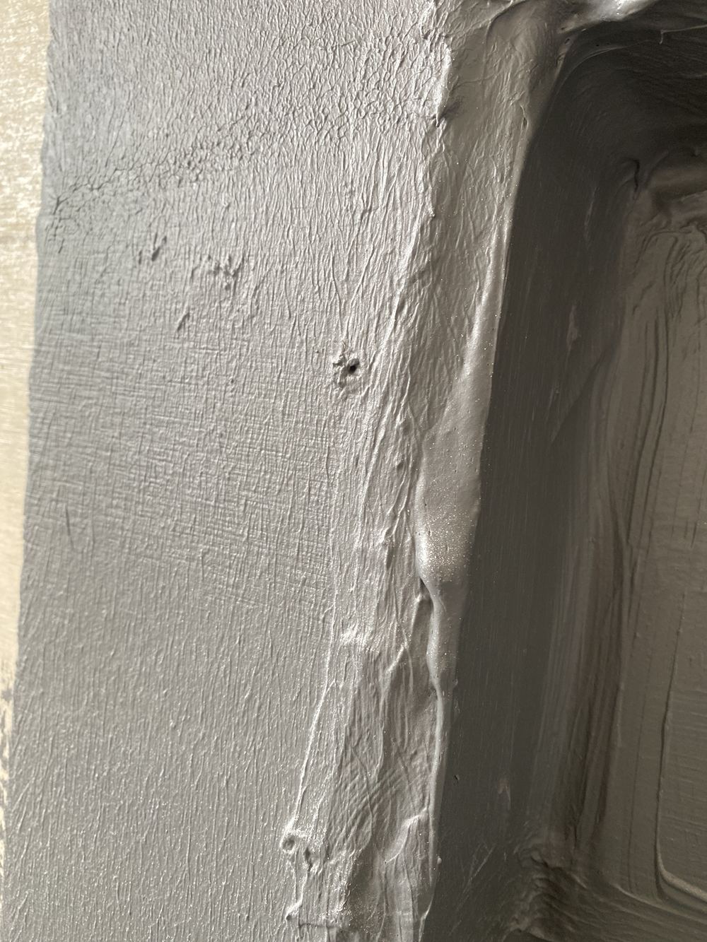 Pinholes and small pockets in the membrane inside a shower niche, found during a waterproofing inspection in Carlingford
