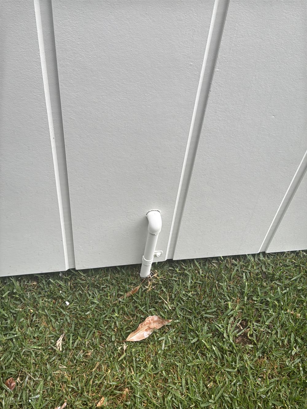 Pipe penetration through an external wall left without grout or sealant, found during a handover inspection in Castle Hill